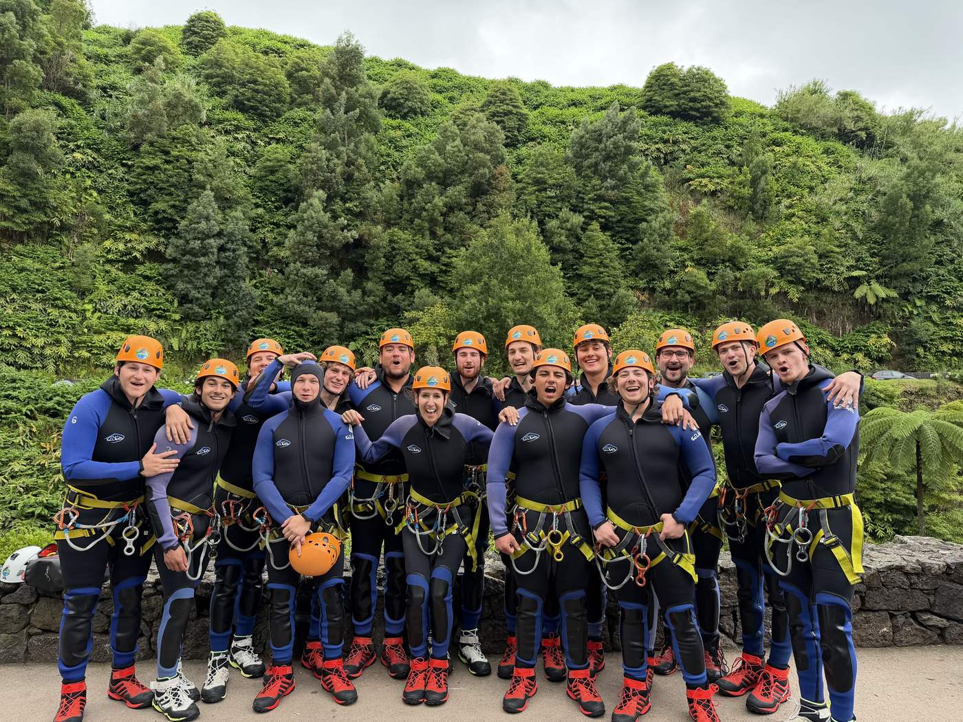 Providence Farm residents canyoning together in wetsuits and helmets