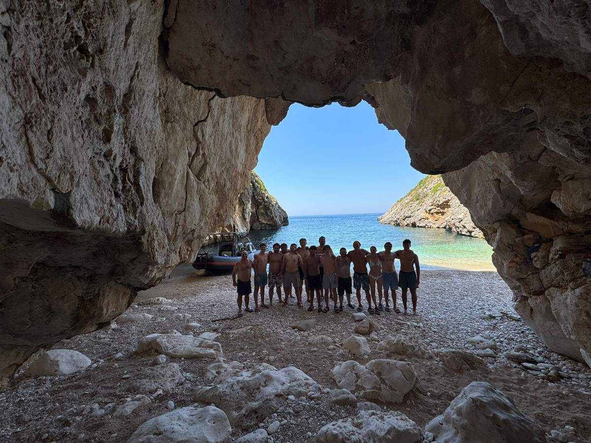 Providence Farm Peak Experience group on the beach through a sea cave