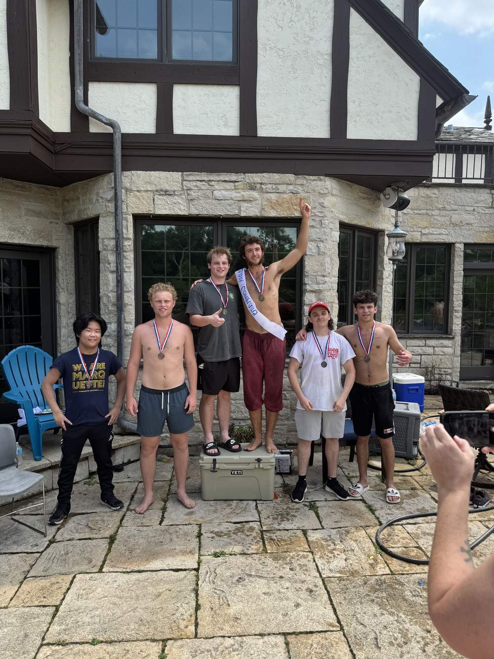 Providence Farm residents celebrating with medals on the patio of the house in Northbrook